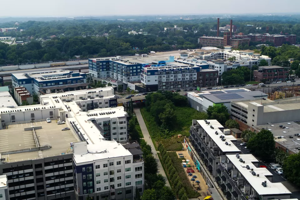 Aerial view of Atlanta BeltLine trail with colorful outdoor patio umbrellas and buildings.
